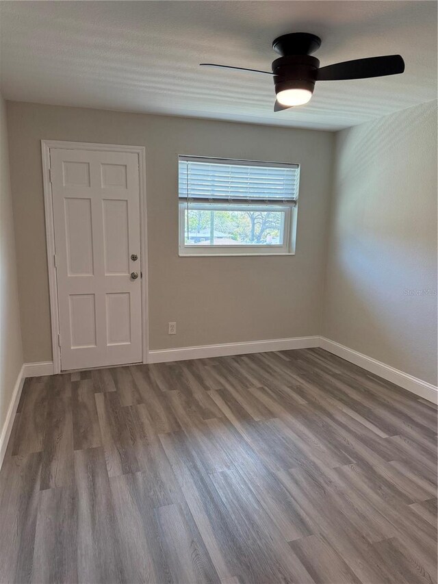 1000 49th St N Unit 309, Saint Petersburg, FL 33710 - unfurnished room with a ceiling fan, baseboards, and wood finished floors