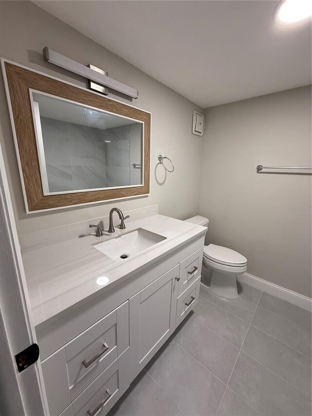 1000 49th St N Unit 309, Saint Petersburg, FL 33710 - bathroom featuring baseboards, vanity, toilet, and tile patterned floors