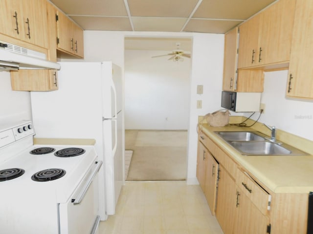 kitchen with white range with electric stovetop, light countertops, under cabinet range hood, light brown cabinets, and a sink