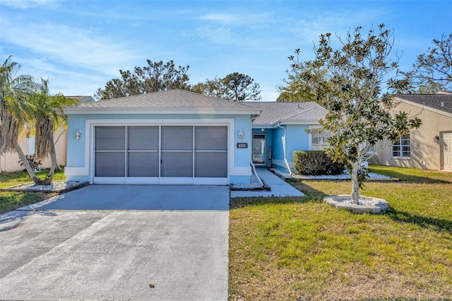 ranch-style house featuring a garage, a front yard, concrete driveway, and stucco siding