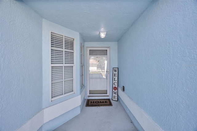 property entrance with stucco siding