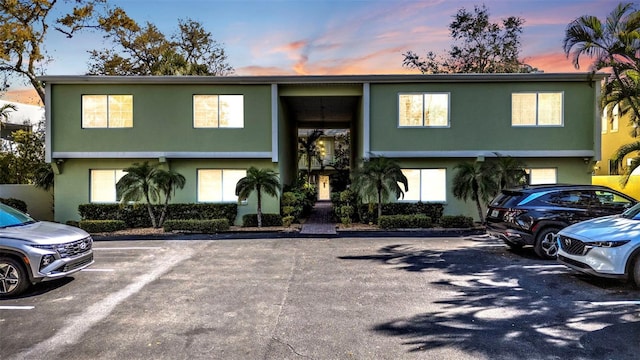 split foyer home featuring uncovered parking and stucco siding