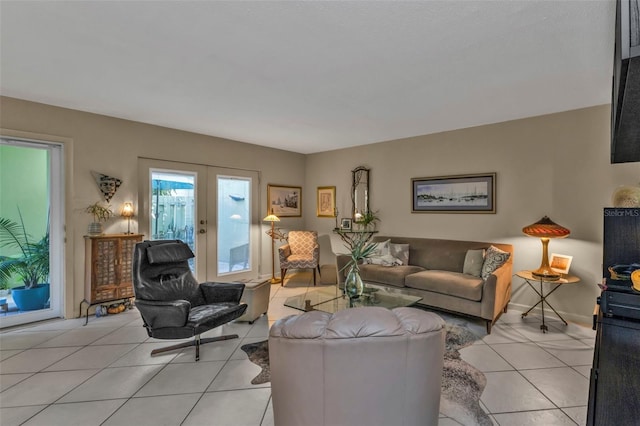 living room featuring light tile patterned floors, baseboards, and french doors