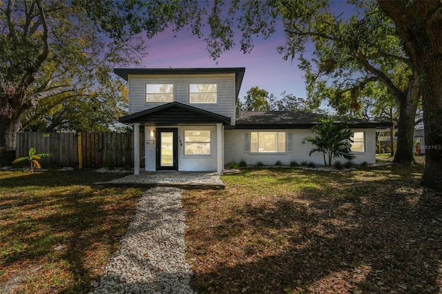 view of front of home featuring a front yard and fence