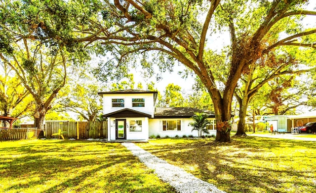 view of front of house with a front lawn and fence