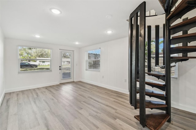 interior space featuring baseboards, wood finished floors, and recessed lighting