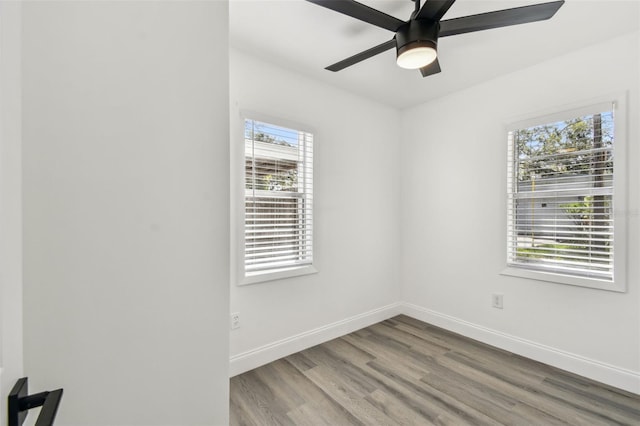 unfurnished room featuring a ceiling fan, baseboards, and wood finished floors