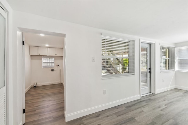 interior space featuring light wood finished floors and baseboards