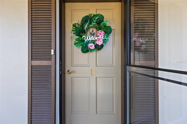 entrance to property featuring stucco siding