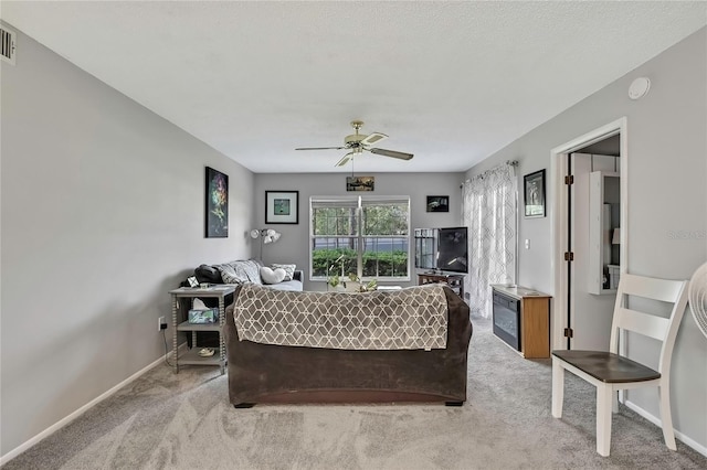 bedroom featuring light carpet, ceiling fan, visible vents, and baseboards