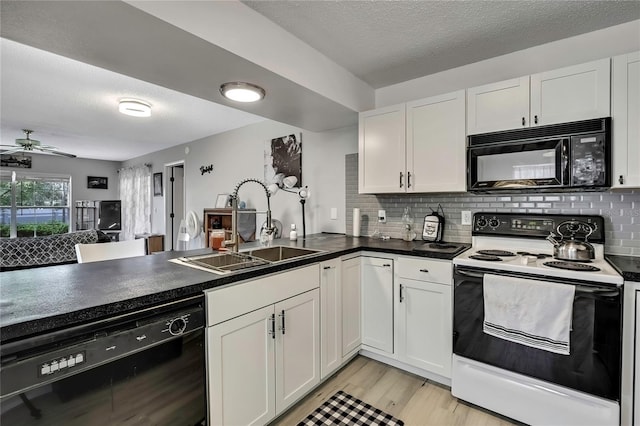 kitchen featuring a sink, white cabinets, decorative backsplash, black appliances, and dark countertops