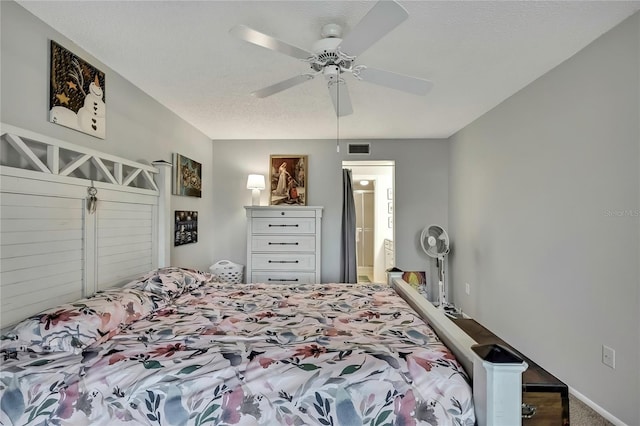 bedroom featuring a textured ceiling, ceiling fan, and visible vents