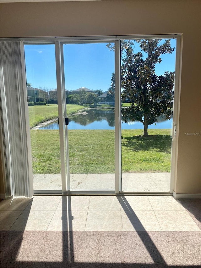 entryway featuring a water view and tile patterned flooring