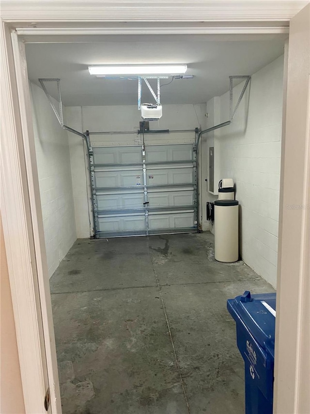 garage featuring electric panel and a garage door opener