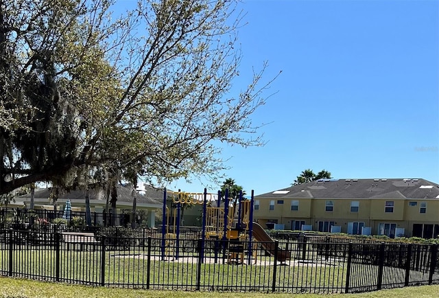 community play area with a yard and fence