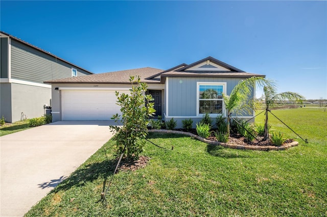 view of front of house with a garage, a front lawn, and concrete driveway