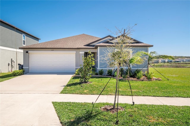 view of front facade featuring a garage, stucco siding, concrete driveway, and a front yard