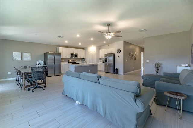 living area with recessed lighting, visible vents, vaulted ceiling, and ceiling fan