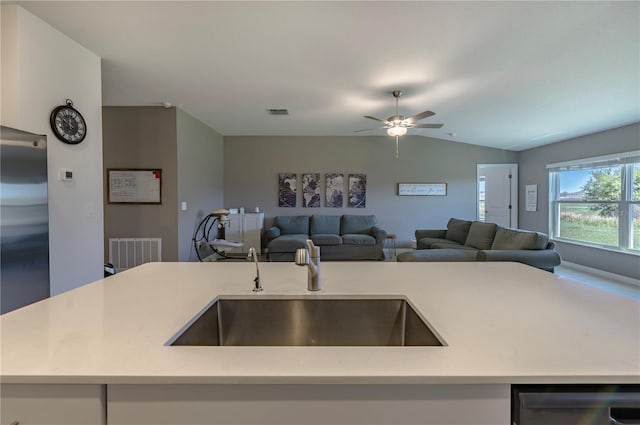 kitchen featuring open floor plan, built in fridge, a sink, and lofted ceiling