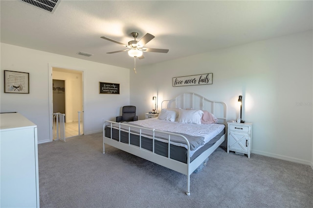 bedroom with a ceiling fan, light colored carpet, visible vents, and baseboards