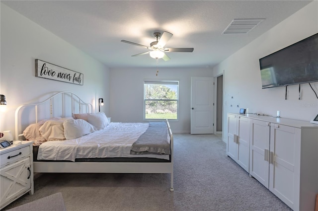 bedroom with light colored carpet, visible vents, ceiling fan, and baseboards