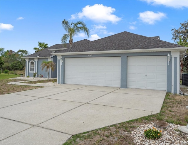 ranch-style house with concrete driveway, central air condition unit, a shingled roof, stucco siding, and a garage
