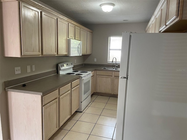 kitchen with white appliances, light brown cabinets, light tile patterned floors, and a sink