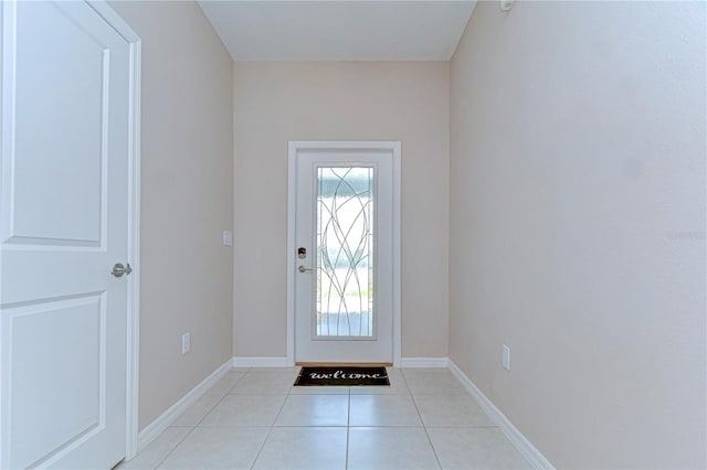 entryway featuring baseboards and light tile patterned floors