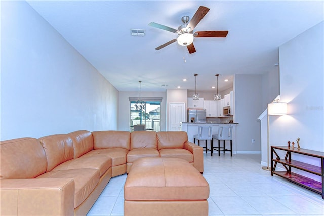 living room with baseboards, visible vents, a ceiling fan, light tile patterned flooring, and recessed lighting