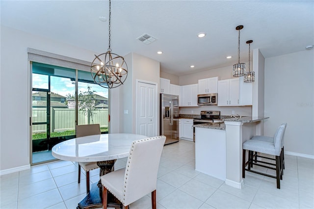 dining space featuring a chandelier, light tile patterned flooring, recessed lighting, visible vents, and baseboards