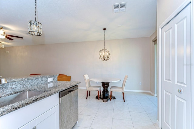 kitchen featuring visible vents, dishwasher, hanging light fixtures, a sink, and light tile patterned flooring