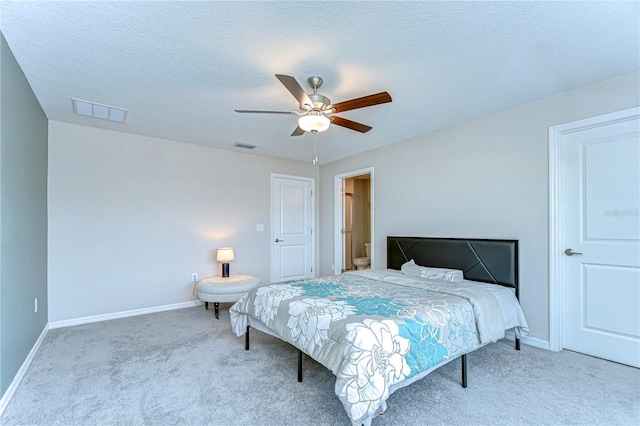 carpeted bedroom featuring a ceiling fan, baseboards, visible vents, and a textured ceiling