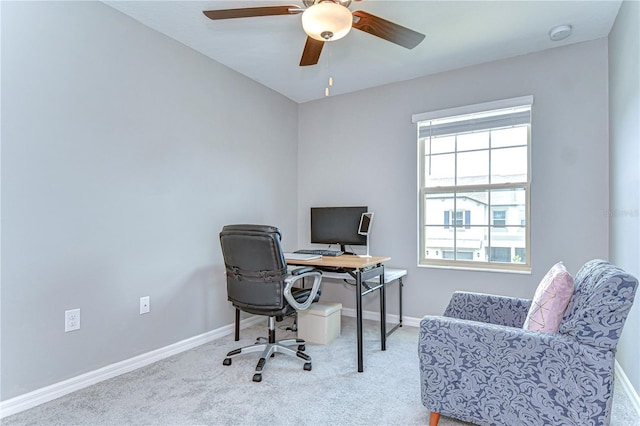 home office with a ceiling fan, baseboards, and carpet flooring