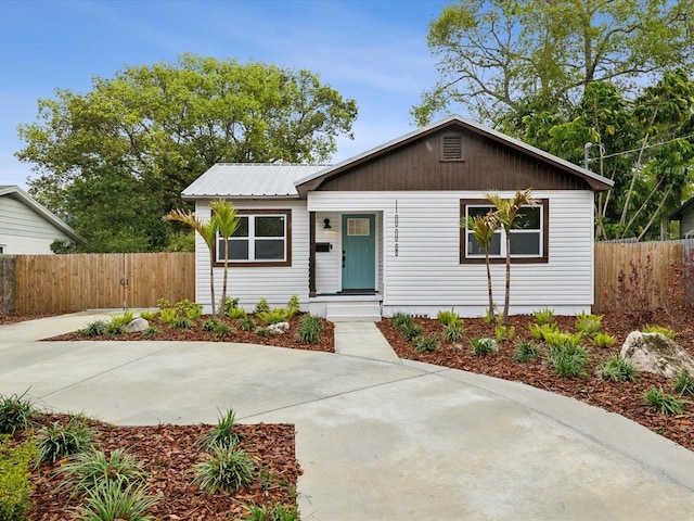 view of front facade with metal roof and fence