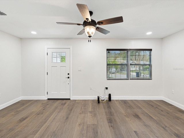 interior space featuring plenty of natural light, baseboards, and wood finished floors