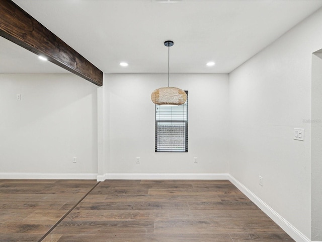 unfurnished dining area with beamed ceiling, recessed lighting, wood finished floors, and baseboards