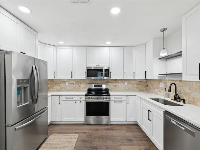 kitchen with a sink, white cabinetry, appliances with stainless steel finishes, and light countertops