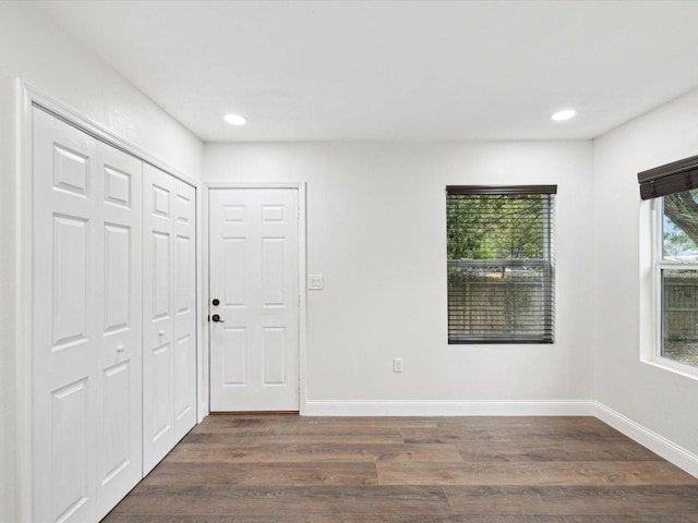 interior space with recessed lighting, baseboards, and dark wood-style floors