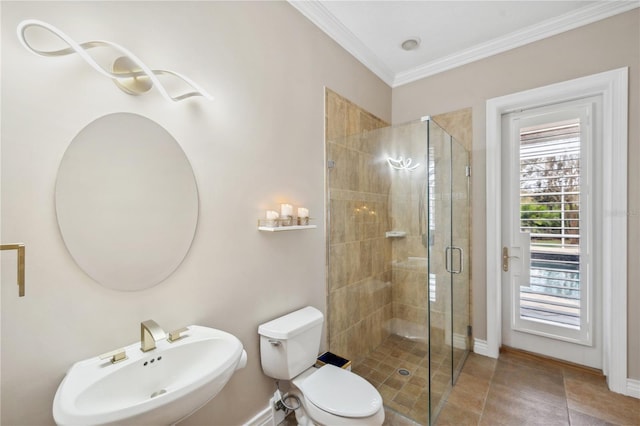 full bath with toilet, ornamental molding, a stall shower, a sink, and baseboards