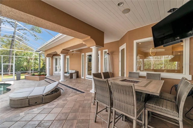 view of patio / terrace with glass enclosure, ceiling fan, an outdoor pool, and french doors