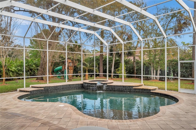 view of swimming pool featuring a patio area, a lanai, and a pool with connected hot tub