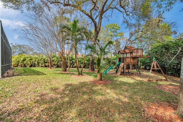 view of yard with glass enclosure and a playground