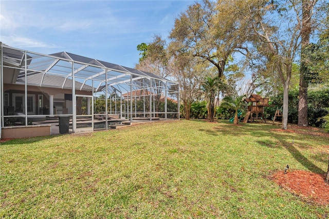 view of yard with a lanai and a playground