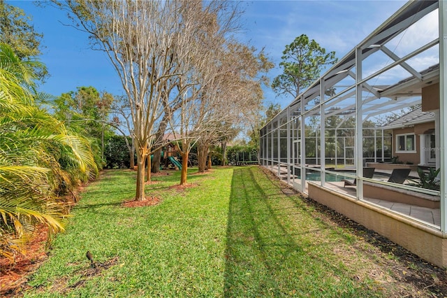 view of yard featuring a patio area, a lanai, a playground, and an outdoor pool