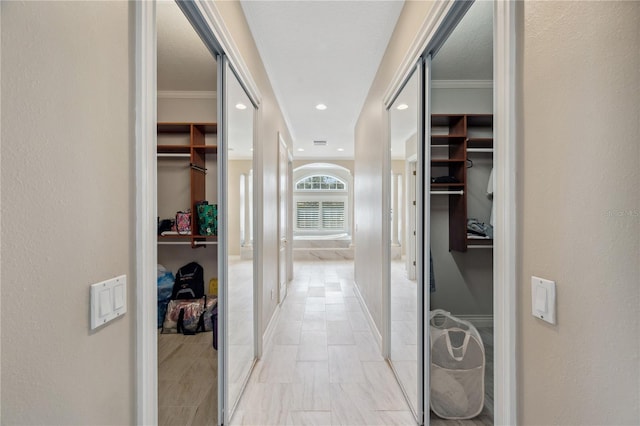 corridor with baseboards, ornamental molding, and recessed lighting