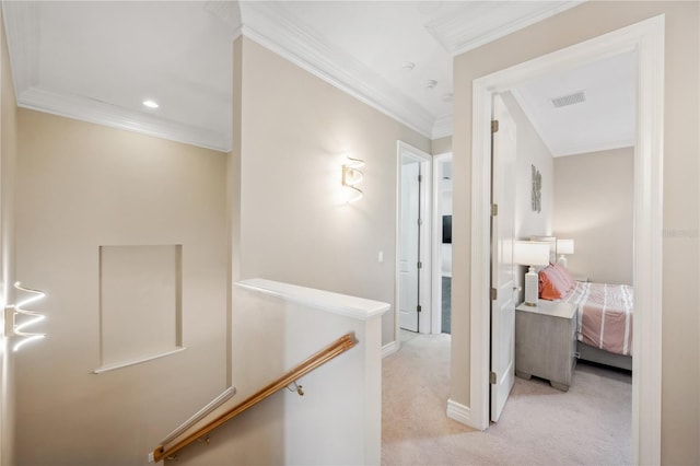 hallway with visible vents, ornamental molding, light carpet, an upstairs landing, and baseboards