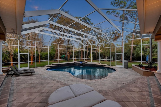 view of pool with a lanai, a patio area, and a pool with connected hot tub