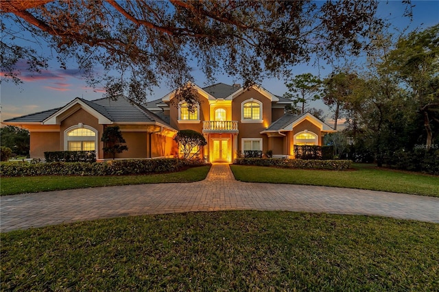 view of front of house with a front lawn and stucco siding