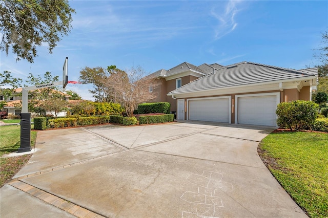 exterior space featuring driveway, stucco siding, an attached garage, and a tiled roof