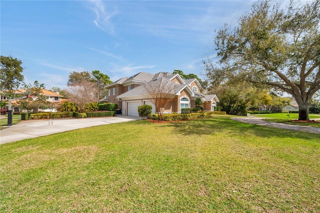 traditional home with an attached garage, concrete driveway, a front yard, and stucco siding